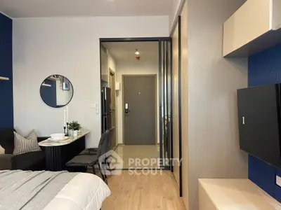 Modern studio apartment with stylish decor and open layout, featuring a cozy dining area and sleek furnishings.
