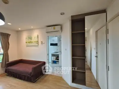 Cozy living room with air conditioning and open kitchen layout in modern apartment.
