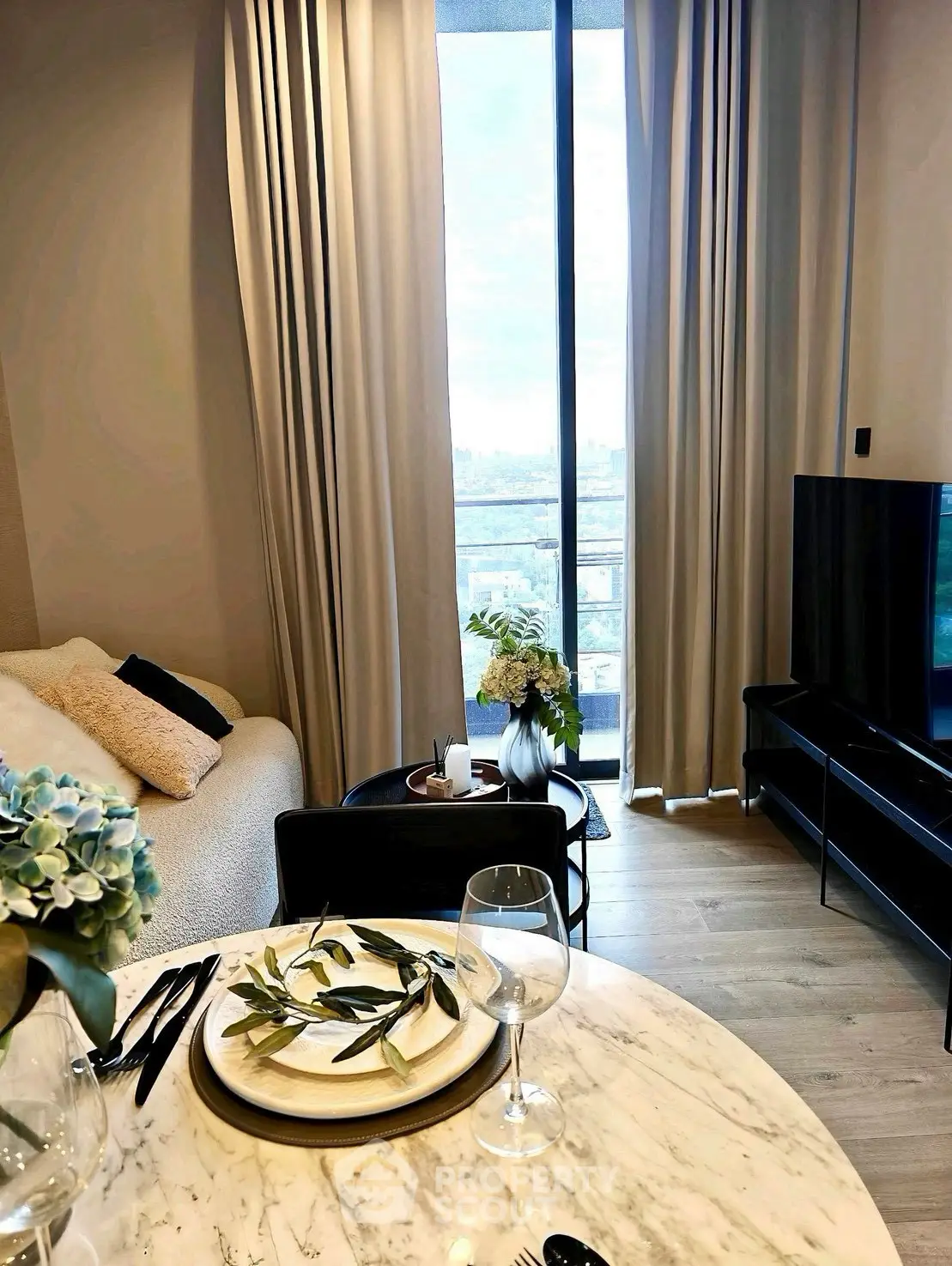 Modern living room with elegant decor and city view from large window