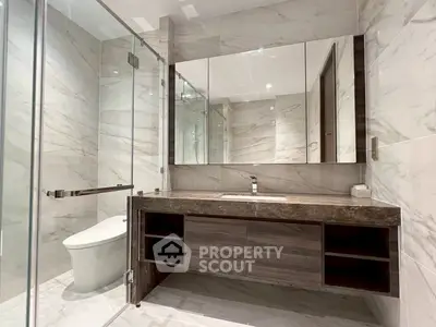 Luxurious modern bathroom with marble tiles and sleek vanity