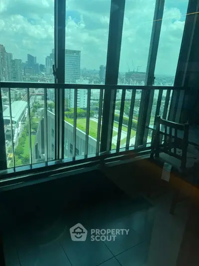 Stunning cityscape view from a modern high-rise balcony with glass railing.