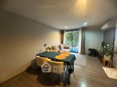 Spacious living room with modern decor and large window view