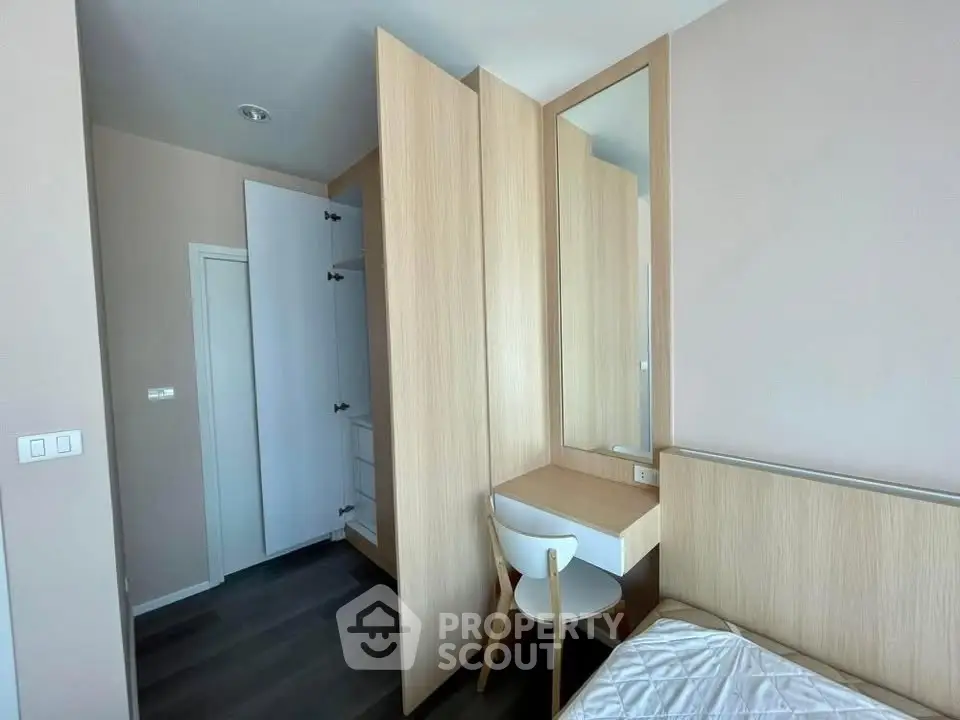 Modern bedroom with sleek wooden furniture and built-in wardrobe