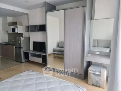 Modern studio apartment with sleek kitchen and stylish wardrobe