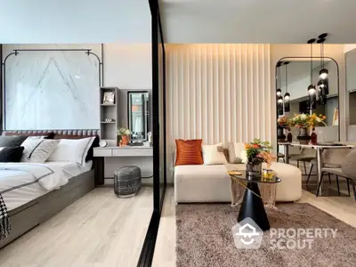 Modern open-concept bedroom and living area with stylish decor and cozy ambiance