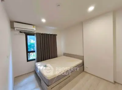Modern bedroom with air conditioning and natural light in a stylish apartment.
