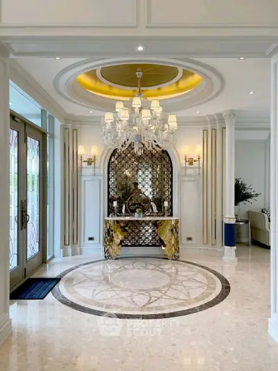 Luxurious entrance with elegant chandelier and ornate decor, showcasing opulent design and sophisticated style.