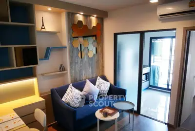 Modern living room with stylish decor and balcony access in a chic apartment.