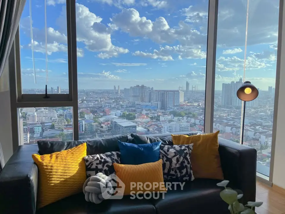 Stunning city view from modern living room with large windows and stylish decor.