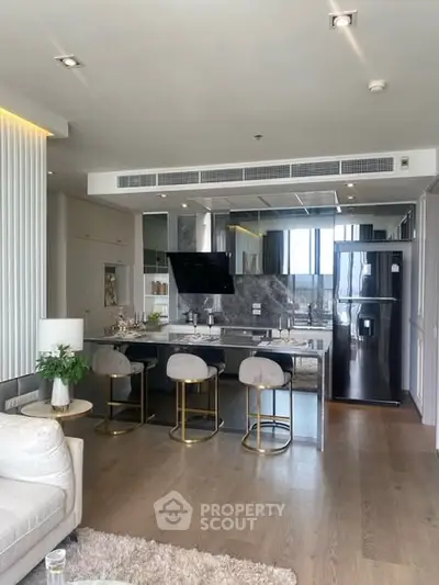 Luxurious open-plan kitchen with sleek modern design and stylish bar seating.