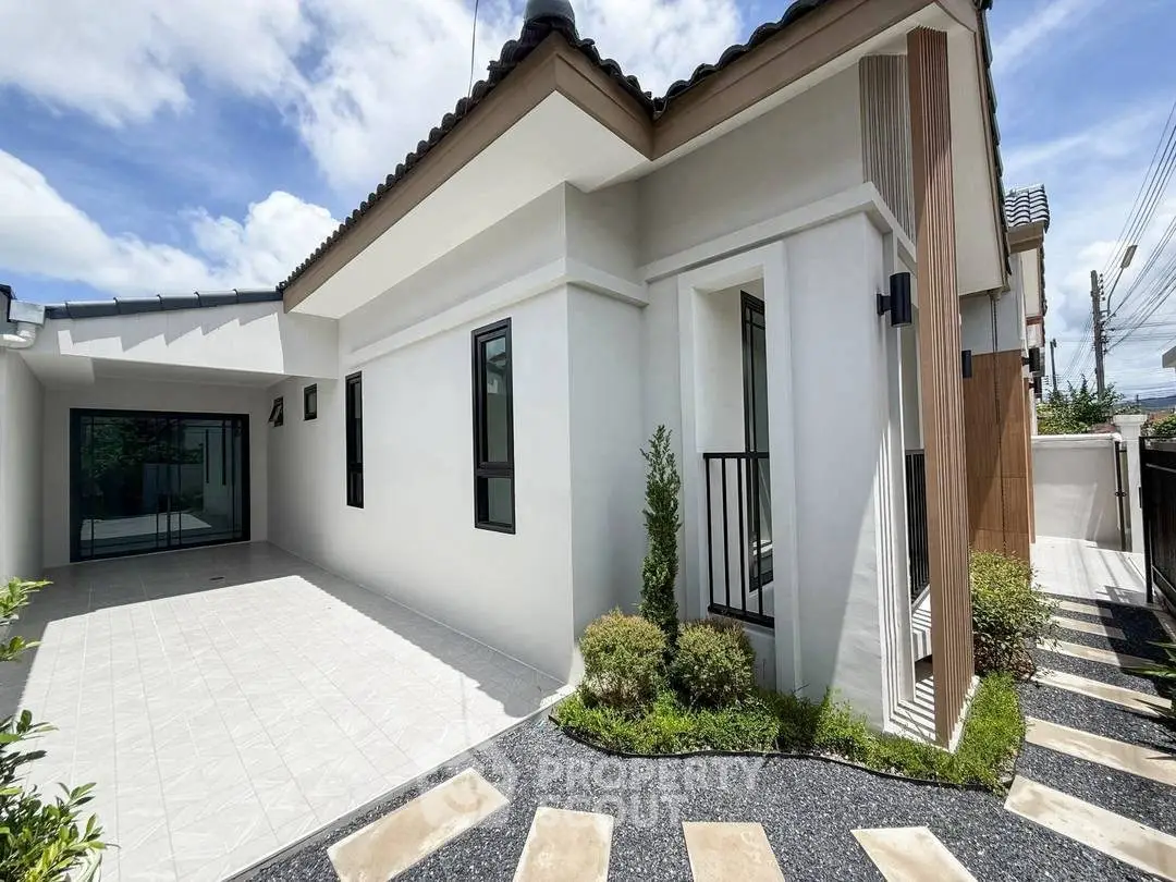 Modern single-story home with sleek exterior design and landscaped garden path.