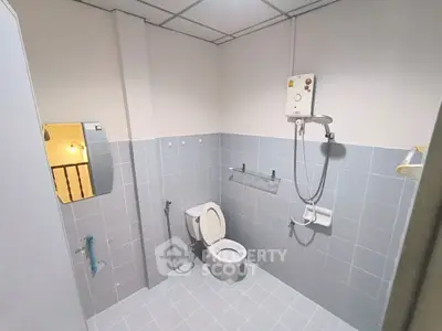 Spacious bathroom with modern fixtures and tiled walls in a contemporary home.