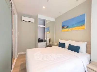 Modern bedroom with stylish decor and mirrored closet doors