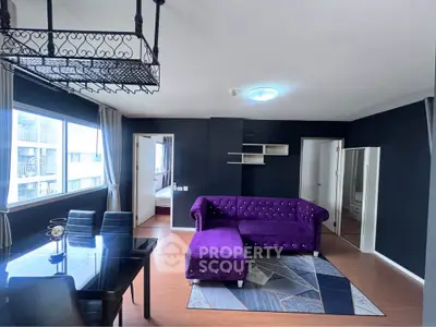 Stylish living room with purple sofa and dining area in modern apartment