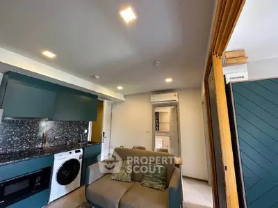 Modern living room with integrated kitchen and laundry appliances