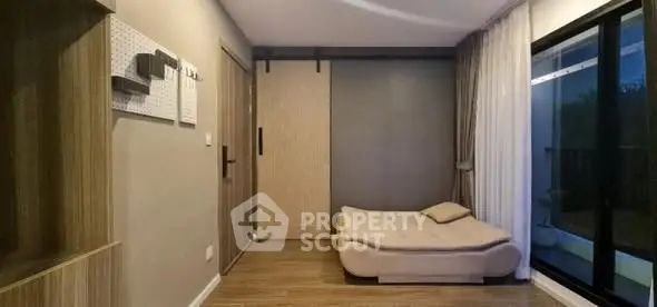 Modern minimalist bedroom with sliding door and large window view.