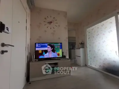 Cozy living room with modern decor and wall-mounted TV, featuring a stylish clock and floral wallpaper.