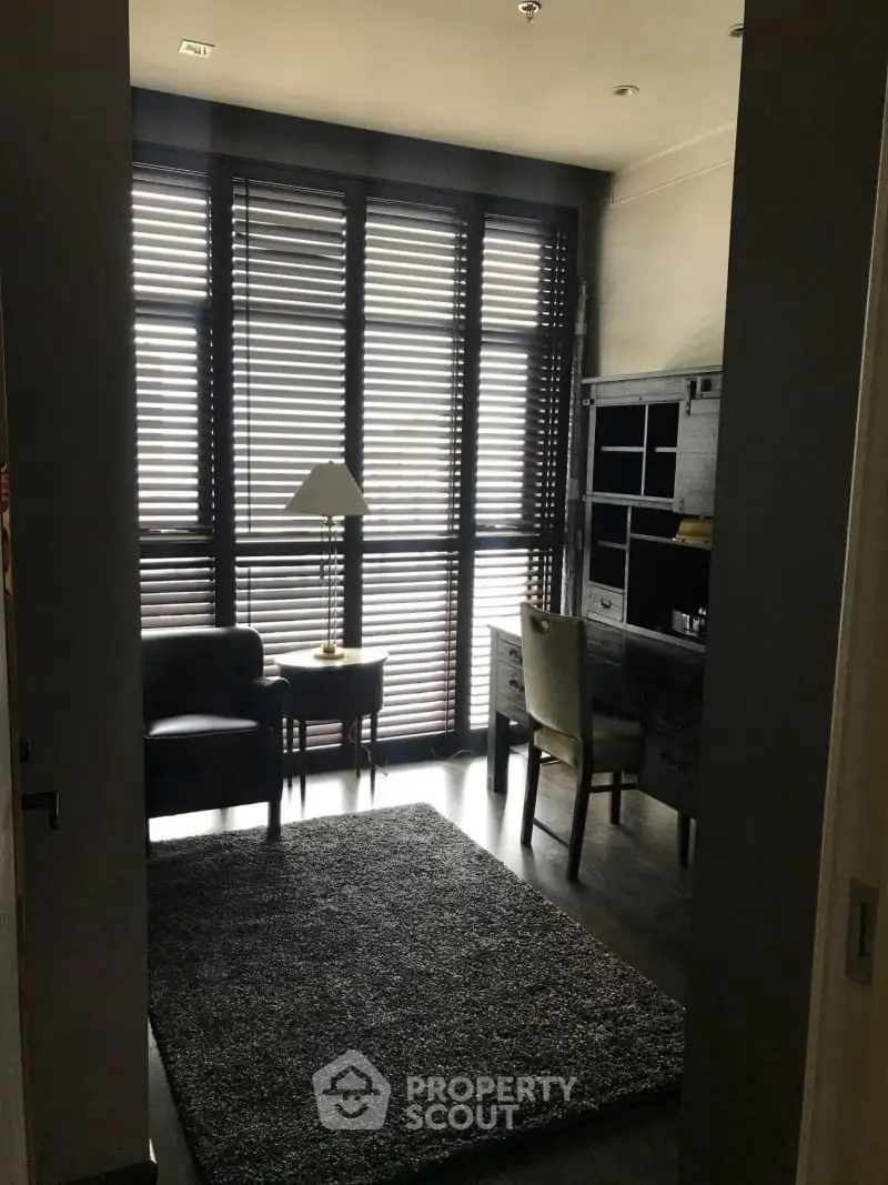 Cozy study room with modern furniture and large windows with blinds