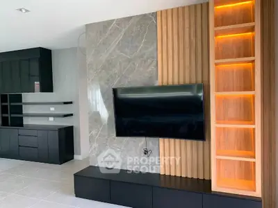 Modern living room with sleek TV setup and stylish shelving