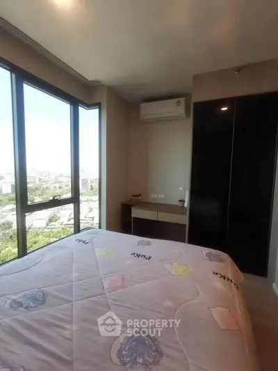 Cozy bedroom with large windows offering a stunning city view, featuring modern air conditioning and sleek design.