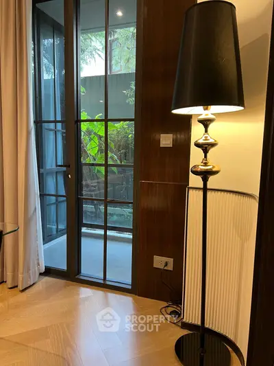 Elegant living room corner with floor lamp and balcony view