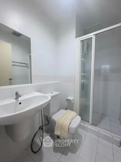 Modern bathroom with sleek fixtures and glass shower enclosure, perfect for a contemporary home.