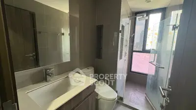 Modern bathroom with sleek fixtures and large window for natural light.