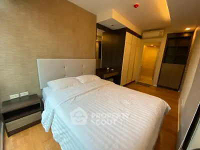 Modern bedroom with elegant design and ample storage in a stylish apartment.