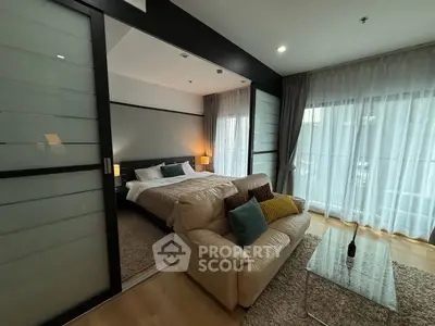 Modern bedroom with sliding glass doors and cozy seating area