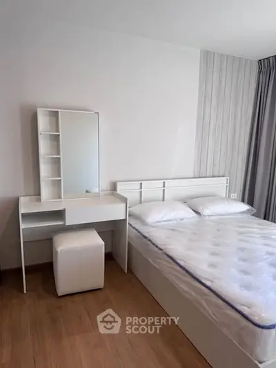 Modern bedroom with sleek white furniture and comfortable mattress, perfect for a restful night's sleep.