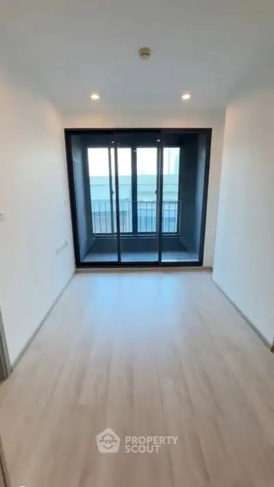 Spacious room with large windows and balcony access in modern apartment