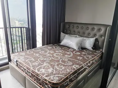 Modern bedroom with stylish bed and city view from large windows