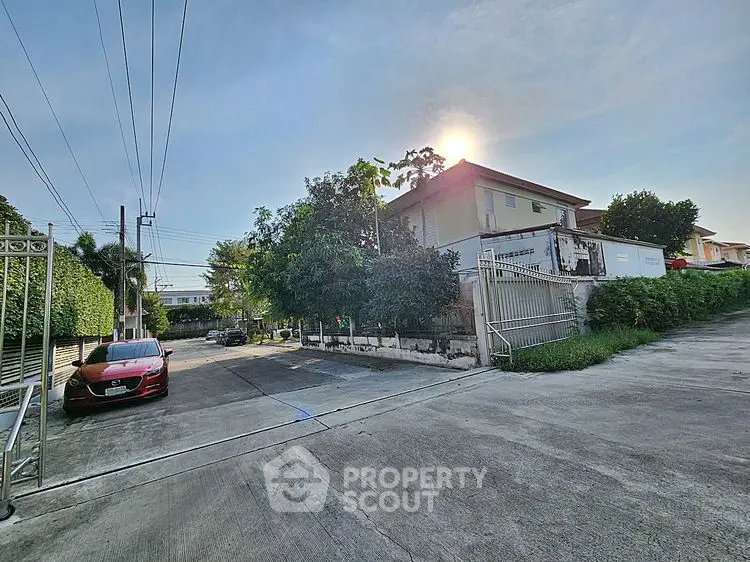 Charming suburban house with lush greenery and driveway in a peaceful neighborhood.