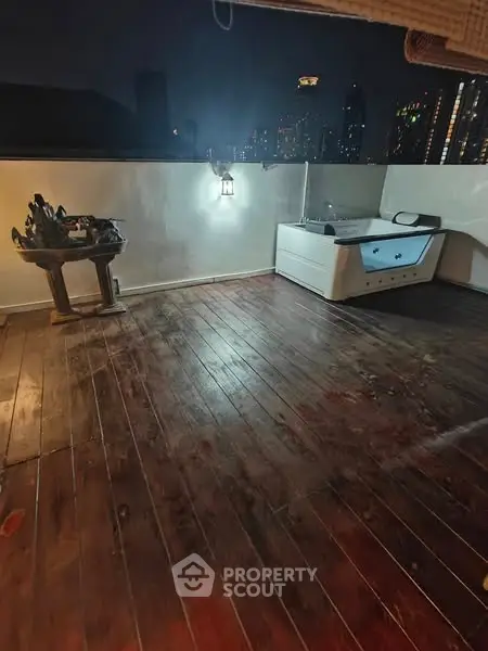 Spacious rooftop with wooden flooring and city skyline view
