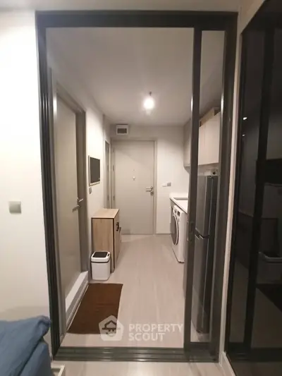 Modern apartment hallway with washing machine and sleek storage solutions