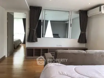 Spacious modern living room with wooden flooring and large windows