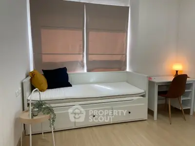 Cozy bedroom with daybed and study desk, perfect for a minimalist lifestyle.