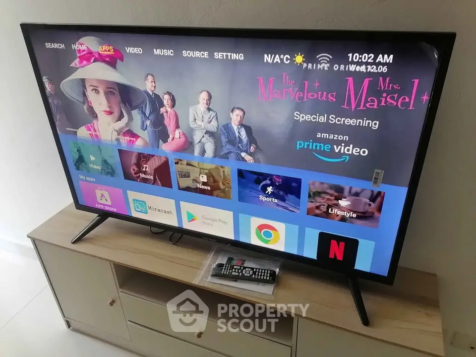 Modern living room with sleek TV setup on stylish wooden stand, showcasing streaming apps and remote control.