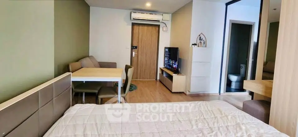 Modern studio apartment with cozy living area and stylish decor