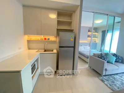 Modern open-plan kitchen and living area with sleek design and natural light