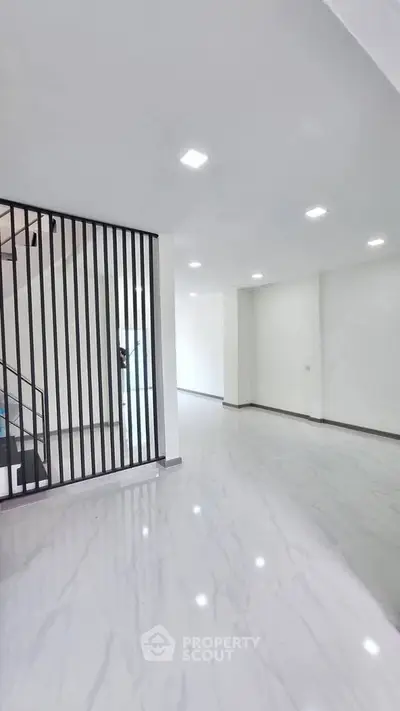 Spacious modern interior with sleek marble flooring and stylish partition, perfect for contemporary living.
