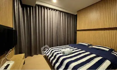 Cozy modern bedroom with striped bedding and wooden panel walls