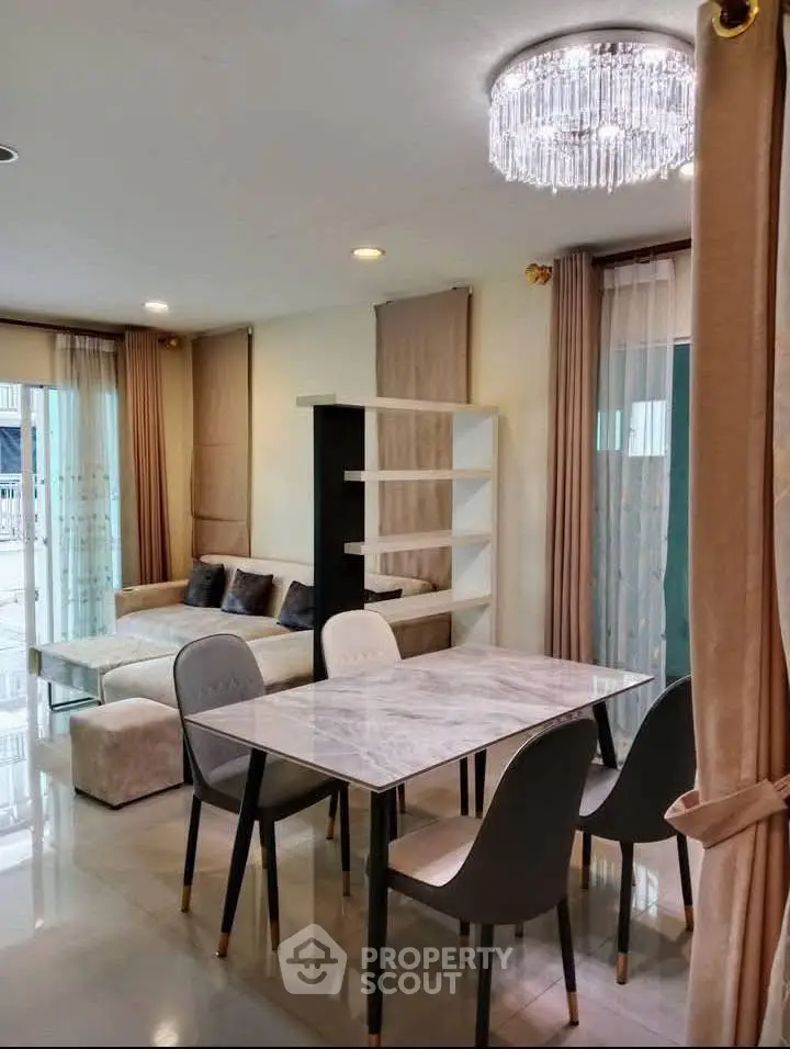 Elegant living room with modern dining area and stylish chandelier