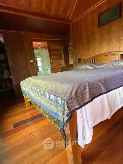 Cozy wooden bedroom with elegant bedspread and warm lighting