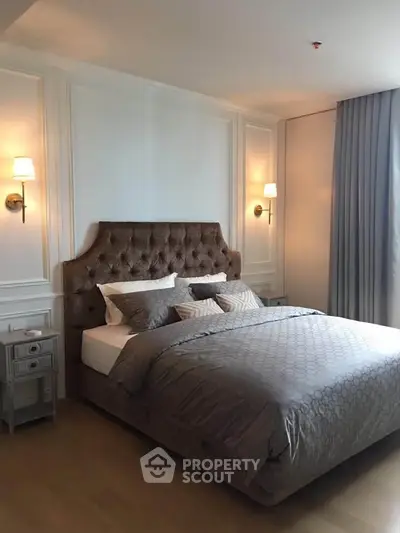 Luxurious bedroom with elegant decor and plush bedding in a modern apartment.