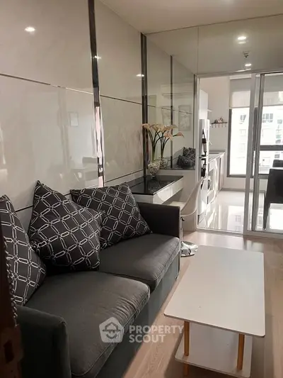 Modern living room with stylish decor and large windows offering natural light.