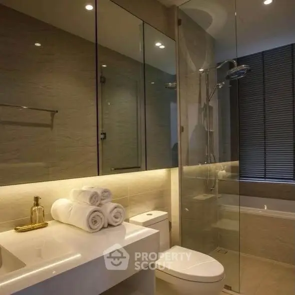 Luxurious modern bathroom with glass shower and elegant lighting