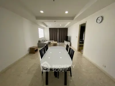 Spacious living room with modern dining area and cozy seating, perfect for family gatherings.
