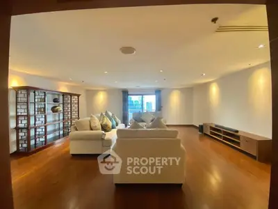 Spacious living room with elegant wooden flooring and modern furniture