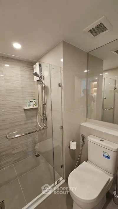 Modern bathroom with glass shower and sleek fixtures, perfect for contemporary living.